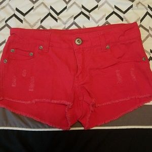 Distressed red jean shorts